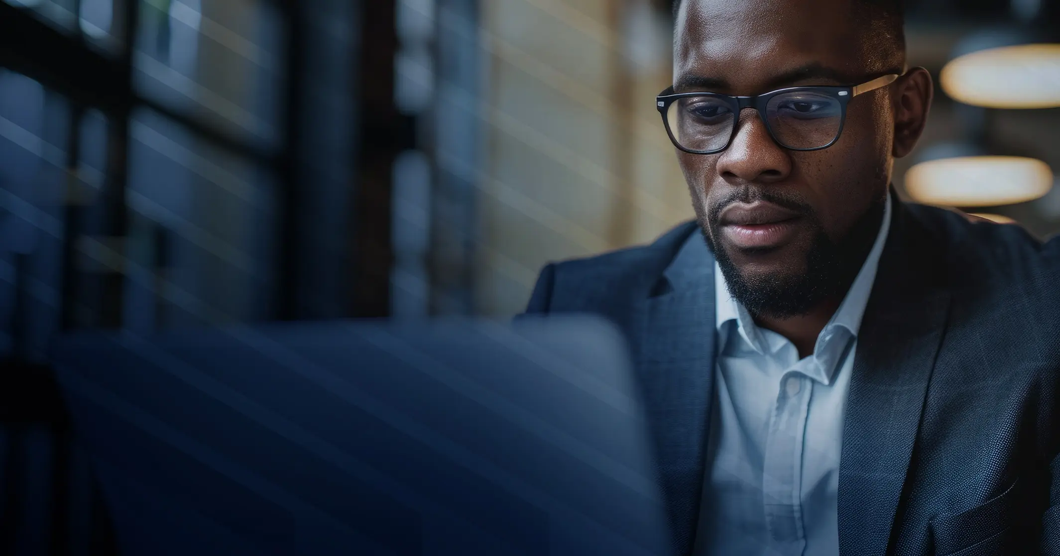 Man in suit working on a laptop